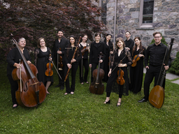 A group of musicians pose with their instruments.