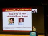 award ceremony, slide of award recipients and one man on stage