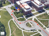 Birdseye view of UMBC Fine Arts Building with red arrows pointing path to entrance of CADVC gallery